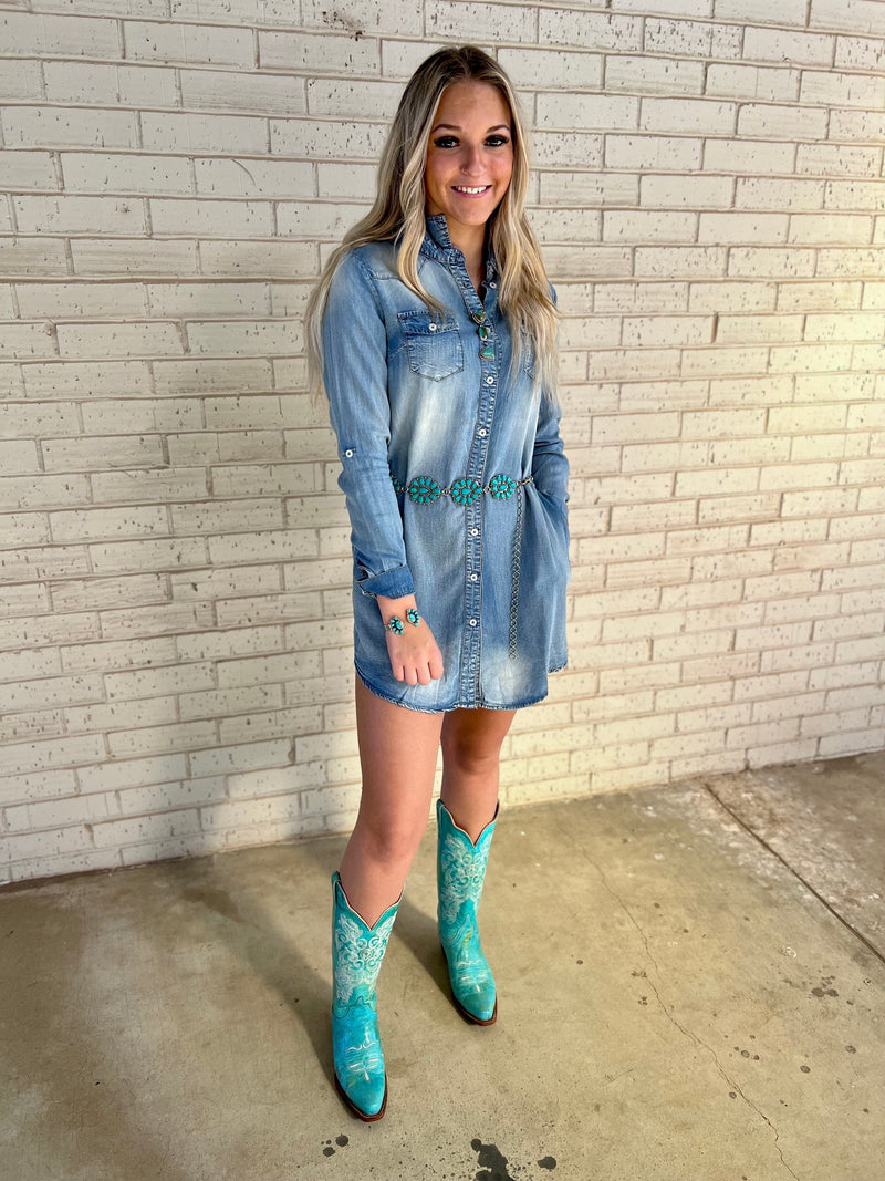 Look stylish and feel cozy in this long-sleeved, collared chambray dress! Featuring a distressed denim fabric, side pockets, and a button-up front, it's the perfect piece for adding a little edge and comfort to any look. Rock it day or night!     100% Lyocell