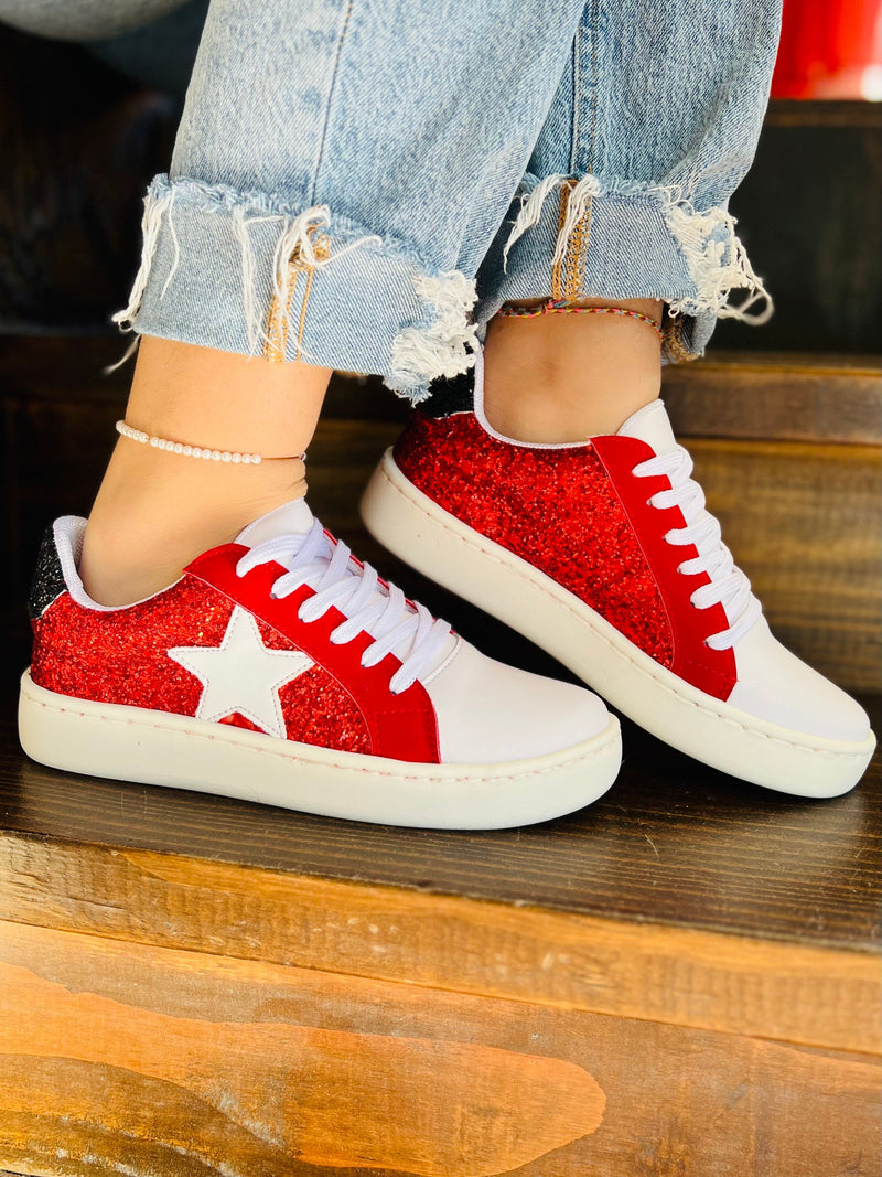 Step up your sneaker game with these Red & Black Sparkling Game Day Sneakers! Perfect for any occasion, these classics will look sharp with any outfit. The white star on the side set into the red sparkles,  gives them a unique kick and their game day style means you'll be ready to show your team spirit. The black sparkling heel sets these shoes apart from the rest. Slay the style game in these!  Cushioned sole for greater comfort   Whole sizes only so size up if between sizes! 