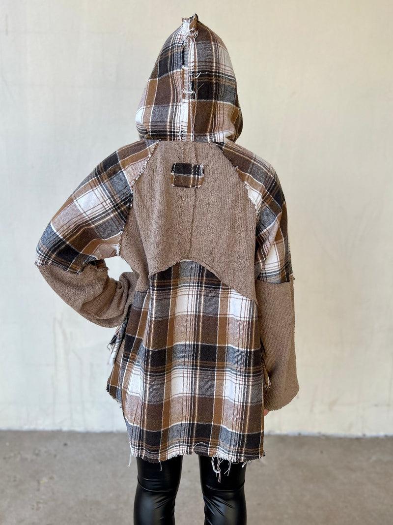 Take a break from the hustle and bustle of everyday life in the Self Care Saturday Plaid Pullover. Crafted from a soft cotton-poly blend and boasting a cool cocoa plaid print, this long sleeve, hooded top sports a frayed grunge look. A button-up front and front pocket finish this sophisticated yet laid-back style.