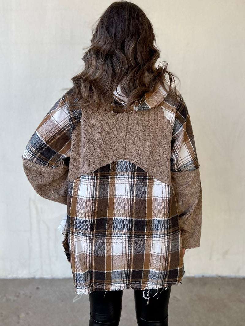 Take a break from the hustle and bustle of everyday life in the Self Care Saturday Plaid Pullover. Crafted from a soft cotton-poly blend and boasting a cool cocoa plaid print, this long sleeve, hooded top sports a frayed grunge look. A button-up front and front pocket finish this sophisticated yet laid-back style.