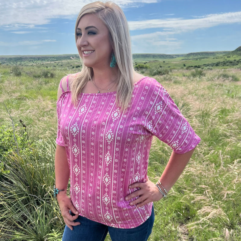 Turn heads in this pink and white off the shoulder top! With a unique aztec print and three stylish straps, this top is a twist of fate you won't want to miss. Perfect for showing off your style with a playful and comfy twist!  55% cotton 40% polyester 5% spandex