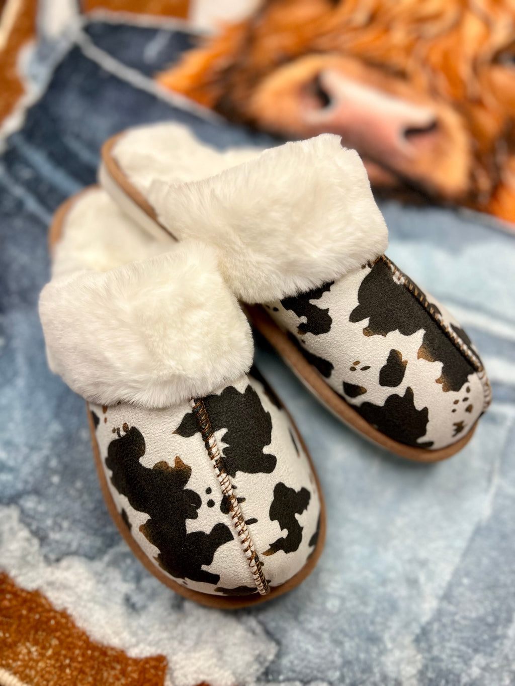 Cow print slippers. Cow house shoes. Fuzzy cow slippers. Brown and white cow print slippers. Get Gussied Up Boutique. Western style. Small business. Woman owned business. 