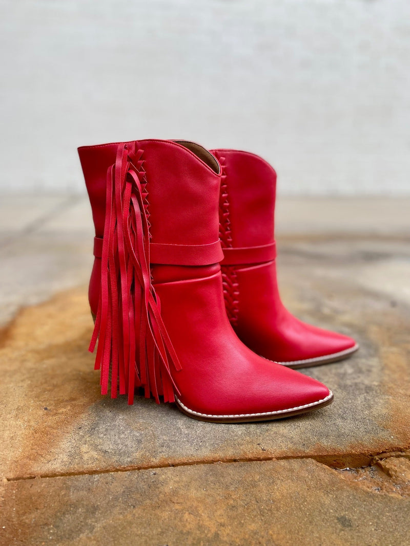 Slip into something a little saucy with these Lady in Red Boots! The ultra-casual fringe-covered booties have a classic western style with a flirty pointed toe, red leather whipstitching and a sassy 3" wood heel, for a look that stands 10" tall. Show 'em who's boss with a splash of daring red!