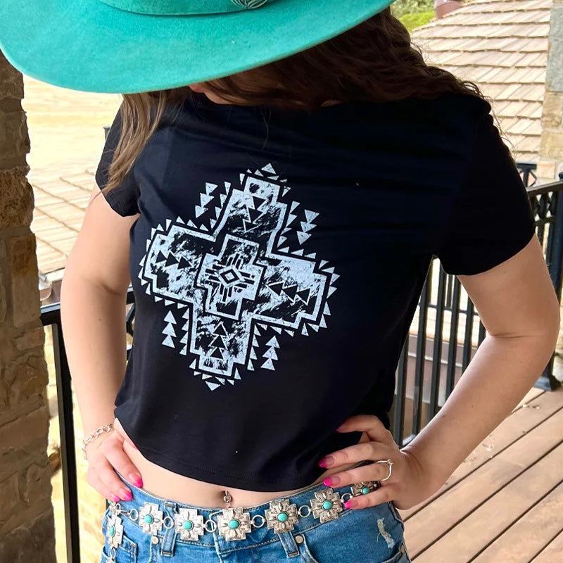 Say hello to your new style staple - our PLUS  River Walk Crop Top! This fun and stylish piece features a black crop top with a stunning white aztec design. Show off your sassy side, and style it up with a pair of jeans for ultra-cool vibes. Ready, set, strut!  OLIVIA IS WEARING A SMALL  65% POLYESTER 35% VISCOSE