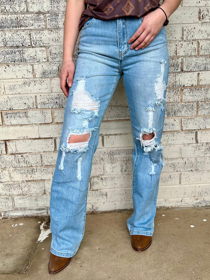 Light wash straight leg jeans. Distressed jeans. Trending denim. Women's jeans. Women's denim. Women's straight leg jeans. Women's fashion. Fashion trends. Jeans. Women's Western Boutique. Women's Western Wear. Online Boutique. Small business. Woman Owned. Fashion boutique. Women's apparel. 