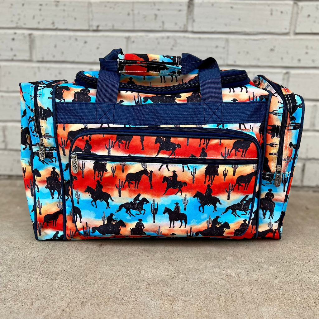 The Desert Cowboy Small Duffle Bag is sure to impress, with its multi colored design, desert horseback scent, cacti, and multiple compartments. Store all your essentials in one stylish and convenient bag. Perfect for any adventure.