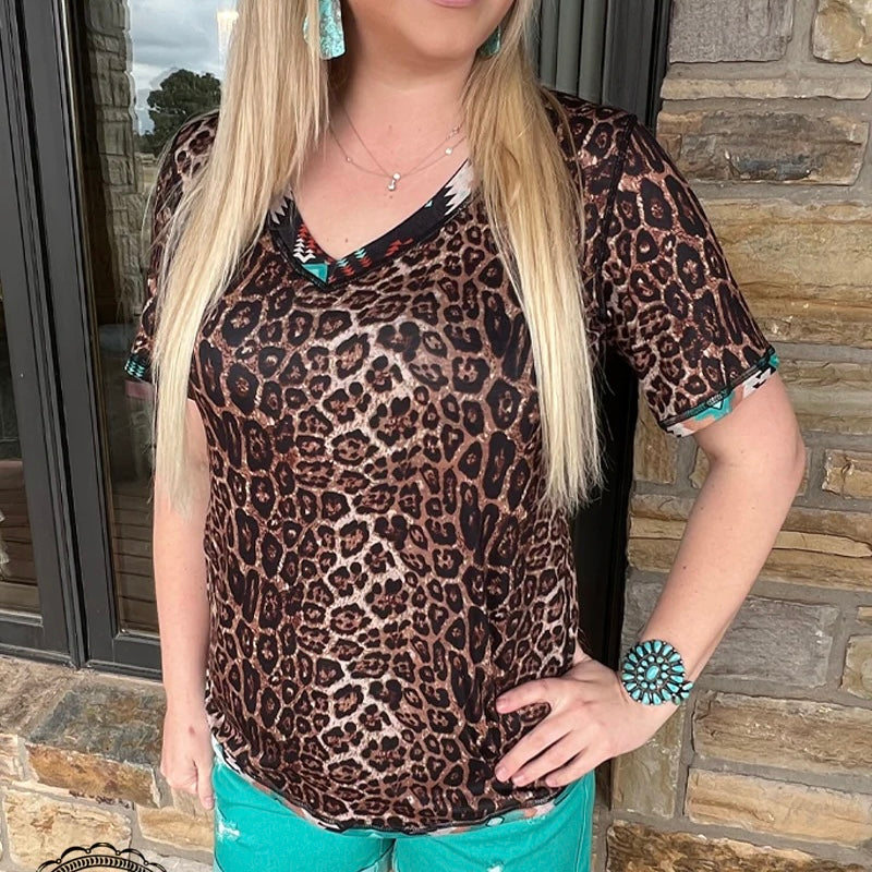 Put your style in double trouble with this reversible top! Whether you're looking to stand out in cheetah or blend in with subtle aztec, this top has got you covered. With the PLUS Twice the Trouble, you don't have to choose between two good looks—you can have them both!  50% Polyester, 45% Cotton, 5% Spandex