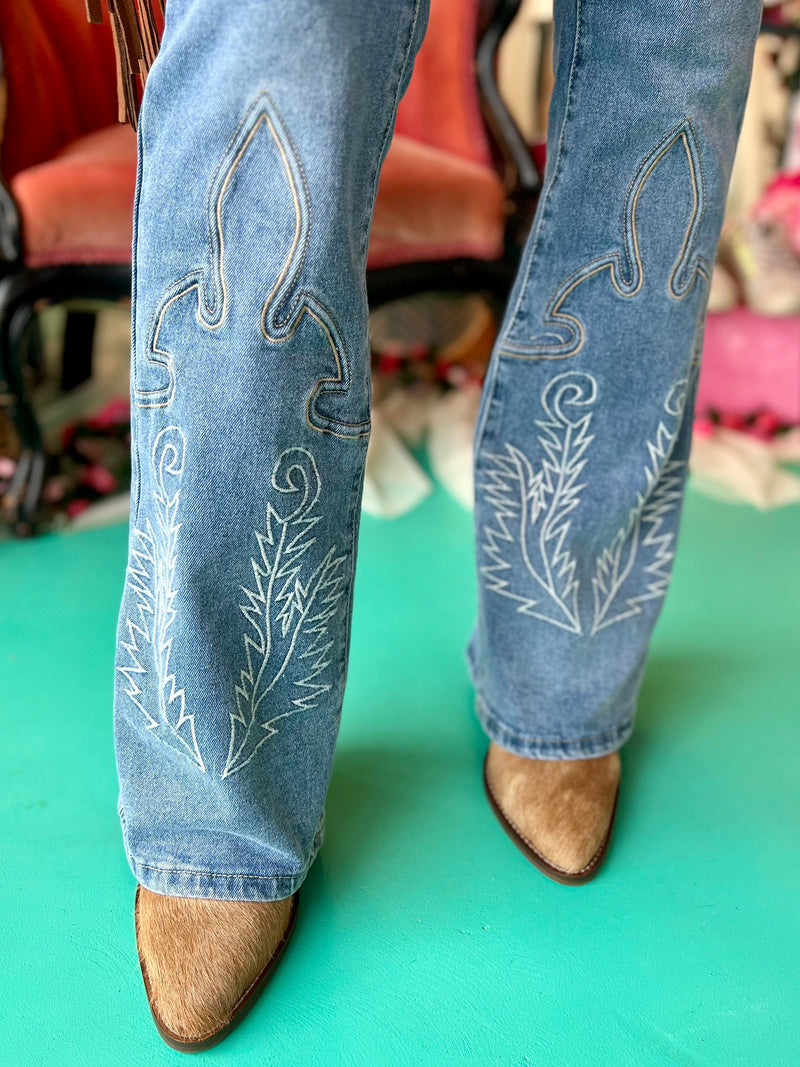Stitched Denim bootcut jeans. Cowboy boot stitching jeans. Bootcut light wash denim jeans. Vintage jeans. Women's western boutique. Women's western fashion. Woman owned. Western boutique. Rodeo apparel. Western apparel. 
