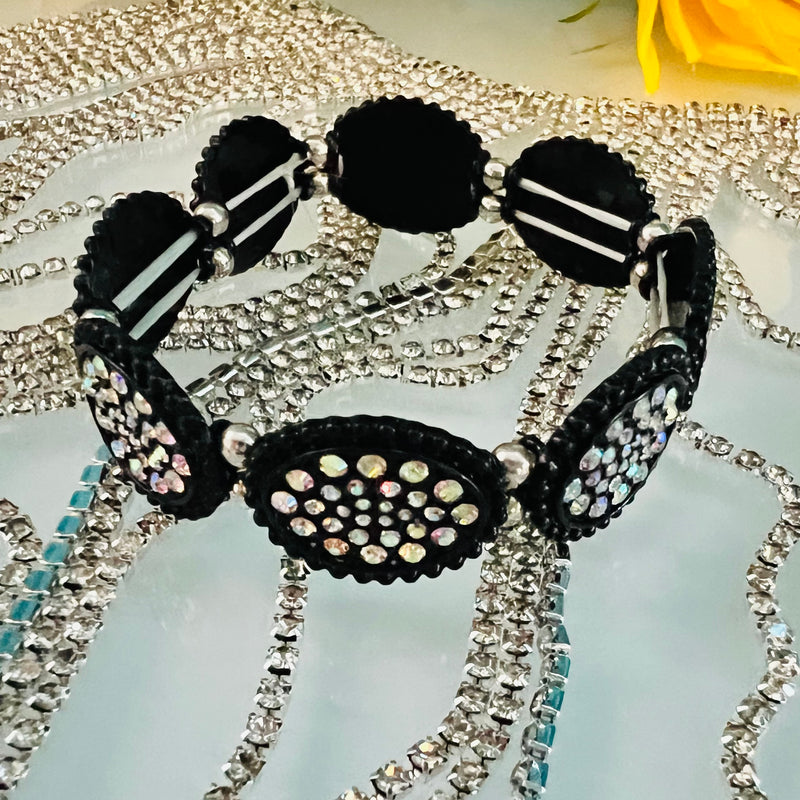 This Rhinestone Cowgirl Black Stretch Bracelet features a western concho style oval casting and rhinestone paving for a bold, eye-catching look. Adjustable for a comfortable fit, this bracelet is the perfect accessory for any cowgirl’s outfit.