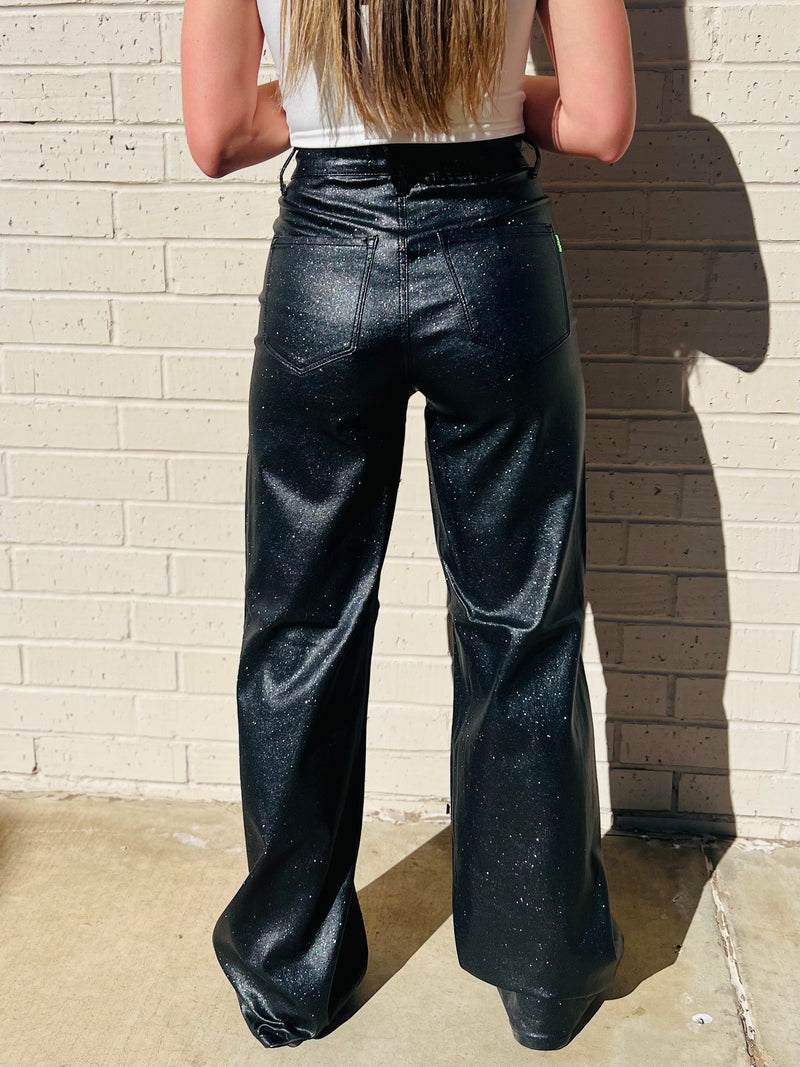 Wide leg stretchy sparkle jeans. Black glittery wide leg jeans. Black shiny wide leg stretch jeans. Women's western boutique. Women's western wear. Small business. Woman owned. Online boutique.