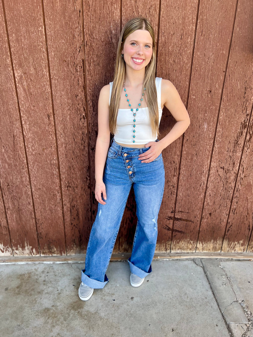 Criss cross waist jeans. Distressed Wide leg jeans. High waisted jeans. Button up straight leg jeans. High waisted medium wash jeans. Medium wash wide leg jeans. Women's western boutique. Women's western wear. Women's western fashion. Small business. Woman owned. Trending fashion.