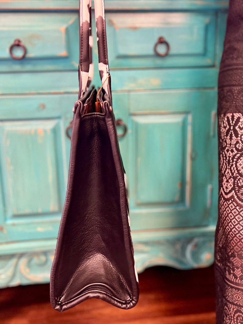 black leather, cow print, bag. Get Gussied Up. Small Business. Woman Owned Boutique. 