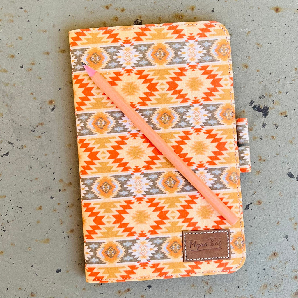 Capture your wildest ideas in the Cornflower Sun Journal. This 8" X 5 1/2" canvas journal comes with a sizzling orange multi colored Aztec print, plus a notepad and pencil to get your creative juices flowing! Perfect for dreamers and free spirits alike! 🤩