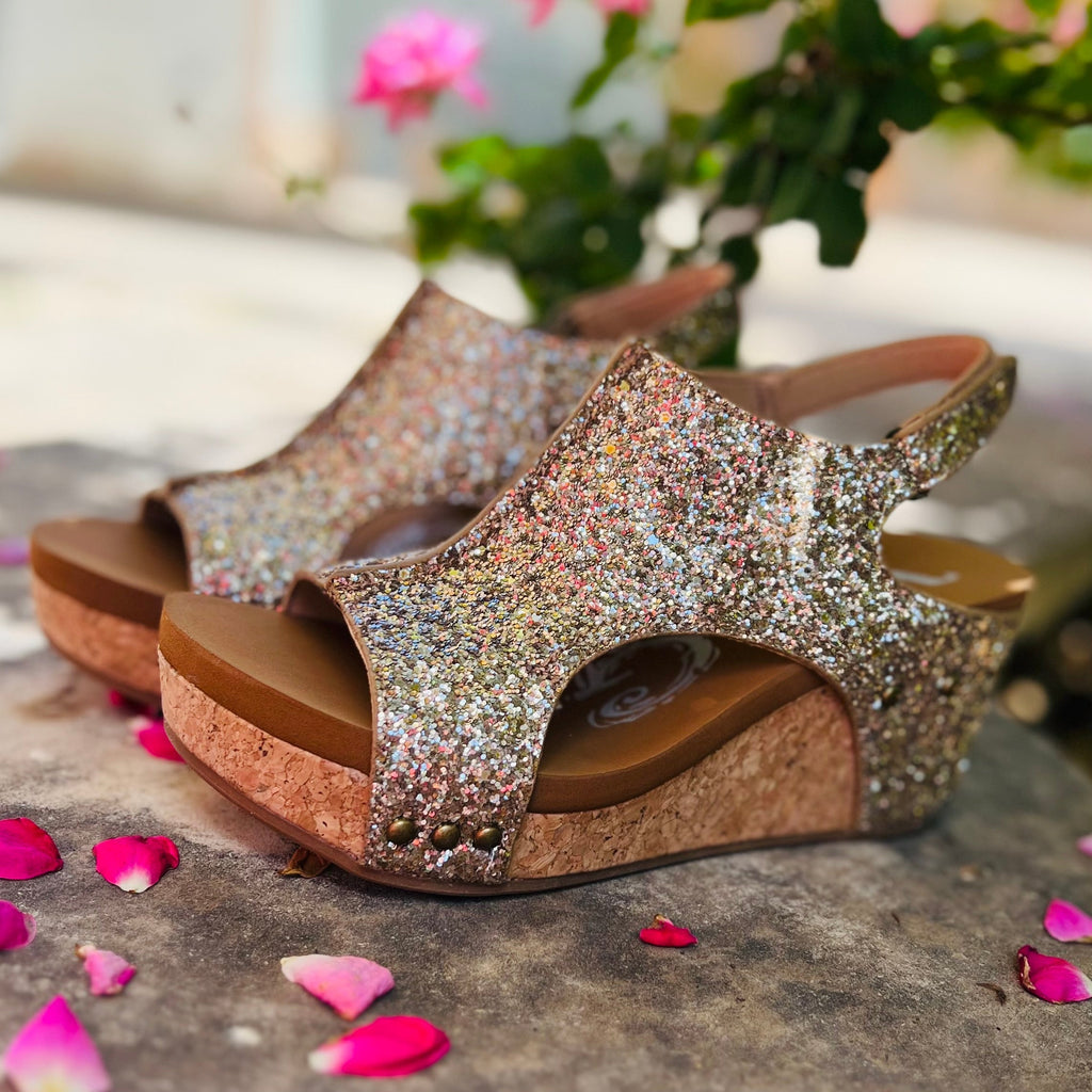 Step out in style with our Gold Glittered Comfort Wedges. This eye-catching design features luxurious gold glitter and a cork sole for added comfort. The sparkly straps and open toe add a touch of glamour, making these wedges perfect for a night out or special occasion.