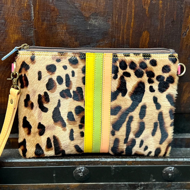 Take a walk on the wild side with the Evie Striped Leather Wristlet and Crossbody! Featuring a stunning leopard print hair on hide, you'll be turning heads wherever you go. The brown leather with yellow, green, and orange leather strip detail is a fashionista's delight, and completes the look with its 8" wristlet handle, 53" adjustable/removeable crossbody strap and zipper closure. So go ahead - take a shot at 9"W X 6"H of sassy style!