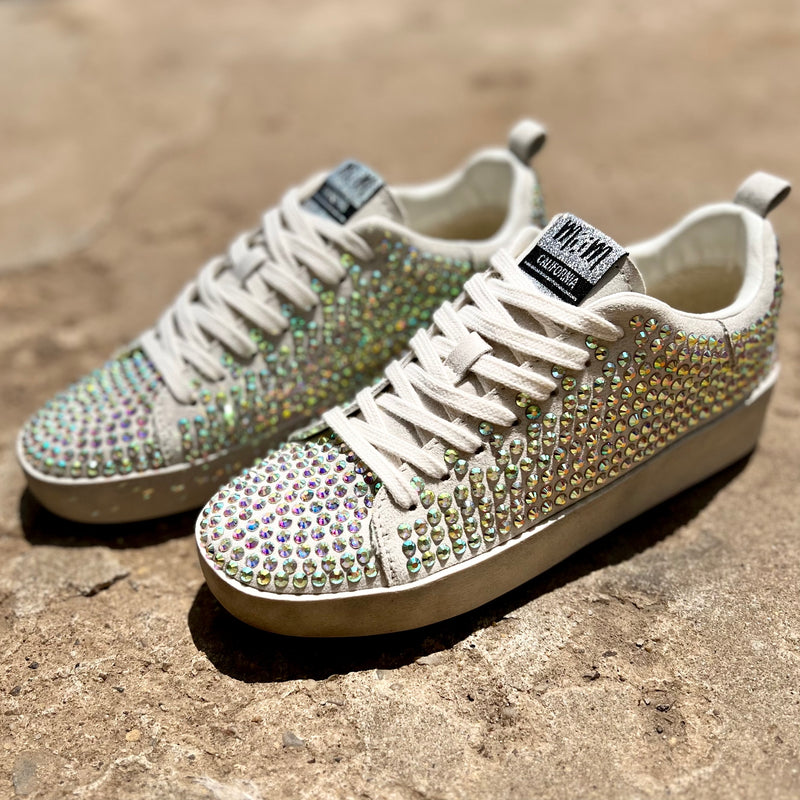 Our Silver Rhinestone Sparkle Sneakers take casual to the next level with the neutral beige colored suede and multi-color all over rhinestone detail. The combination of these features ensures an eye-catching look, while the soft beige suede and comfort sole provides all day comfort.