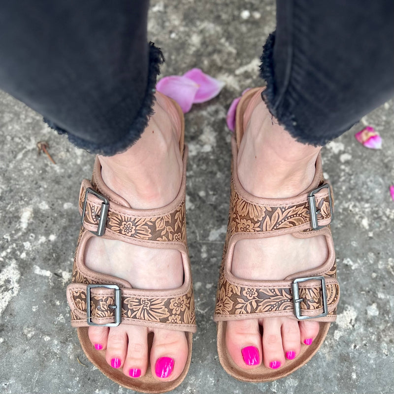 Treat your feet to a touch of luxury with these Berry Comfy Tan Burkies! Featuring a double strap and a intricately tooled floral pattern, these stylish sandals will step up any outfit - not to mention their super comfort! Slip into these tan leather gems and make heads turn!