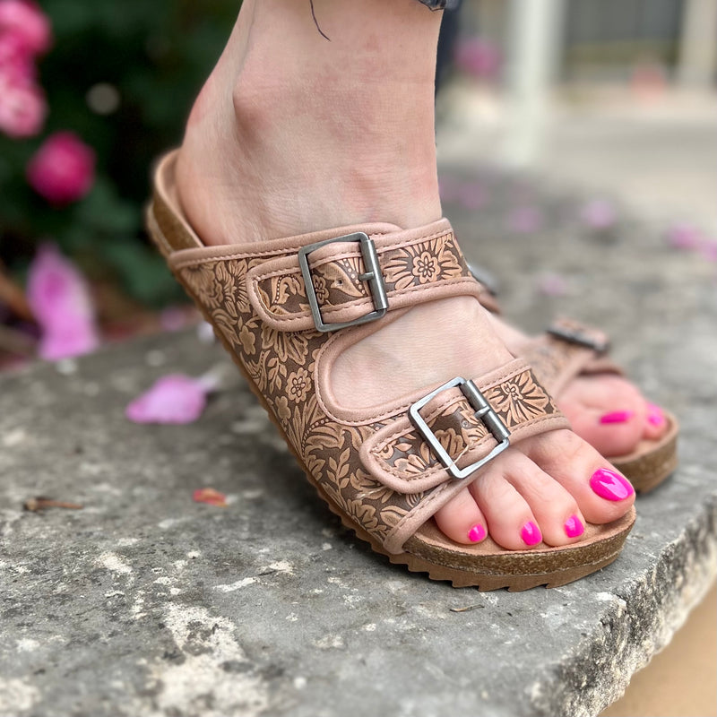 Treat your feet to a touch of luxury with these Berry Comfy Tan Burkies! Featuring a double strap and a intricately tooled floral pattern, these stylish sandals will step up any outfit - not to mention their super comfort! Slip into these tan leather gems and make heads turn!