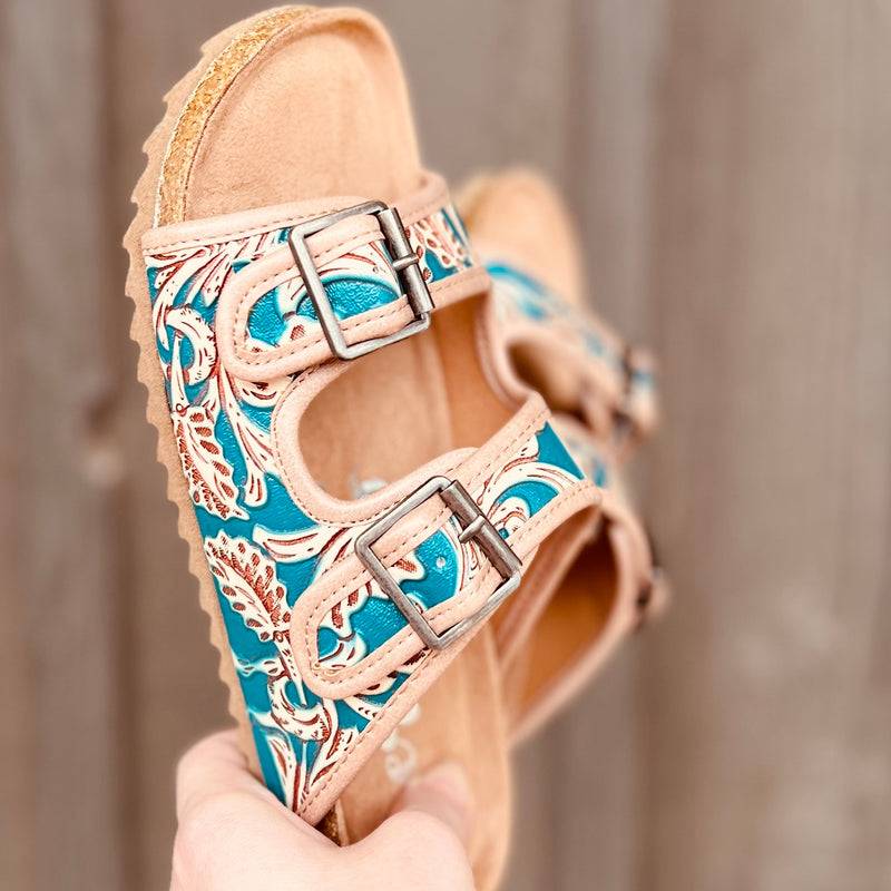  Treat your feet to a touch of luxury with these Berry Comfy Turquoise Burkies! Featuring a double strap and an intricately tooled floral pattern with a beautiful turquoise painted leather, these stylish sandals will step up any outfit - not to mention their super comfort! Slip into these tan leather gems and make heads turn!
