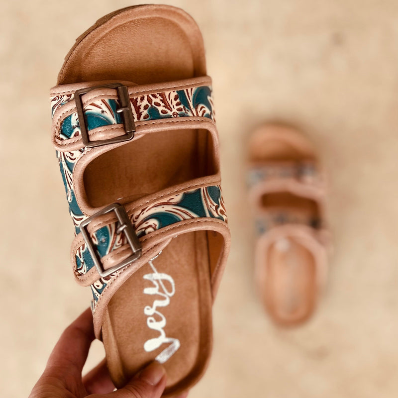 Treat your feet to a touch of luxury with these Berry Comfy Turquoise Burkies! Featuring a double strap and an intricately tooled floral pattern with a beautiful turquoise painted leather, these stylish sandals will step up any outfit - not to mention their super comfort! Slip into these tan leather gems and make heads turn!