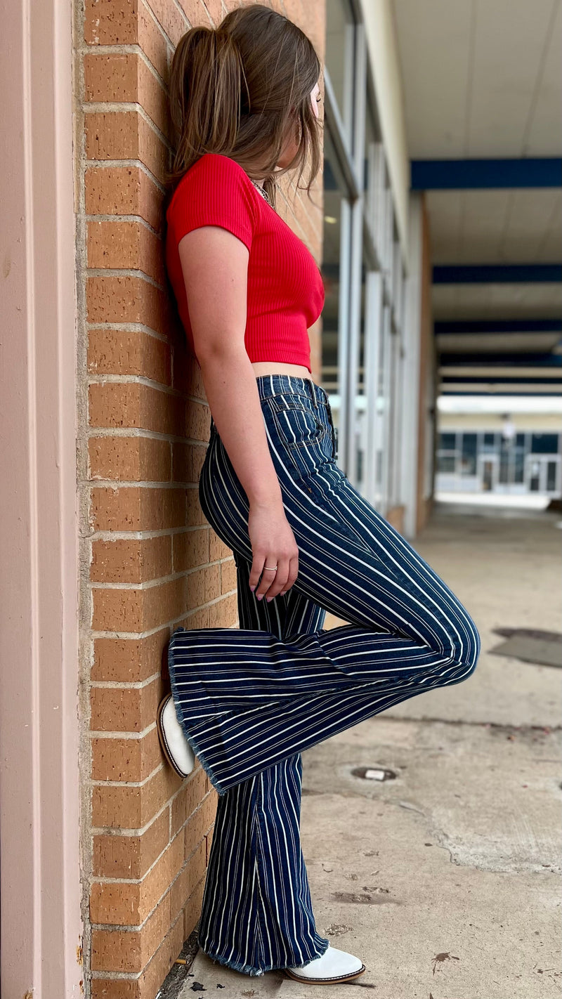 Introducing our Striped Away From It All Flares, the perfect way to stay on trend and channel your inner cowgirl! With its white stripes and mid-rise design, these denim flares will take any rodeo outfit to the next level! Yee-haw in style!  98% Cotton 2% Spandex