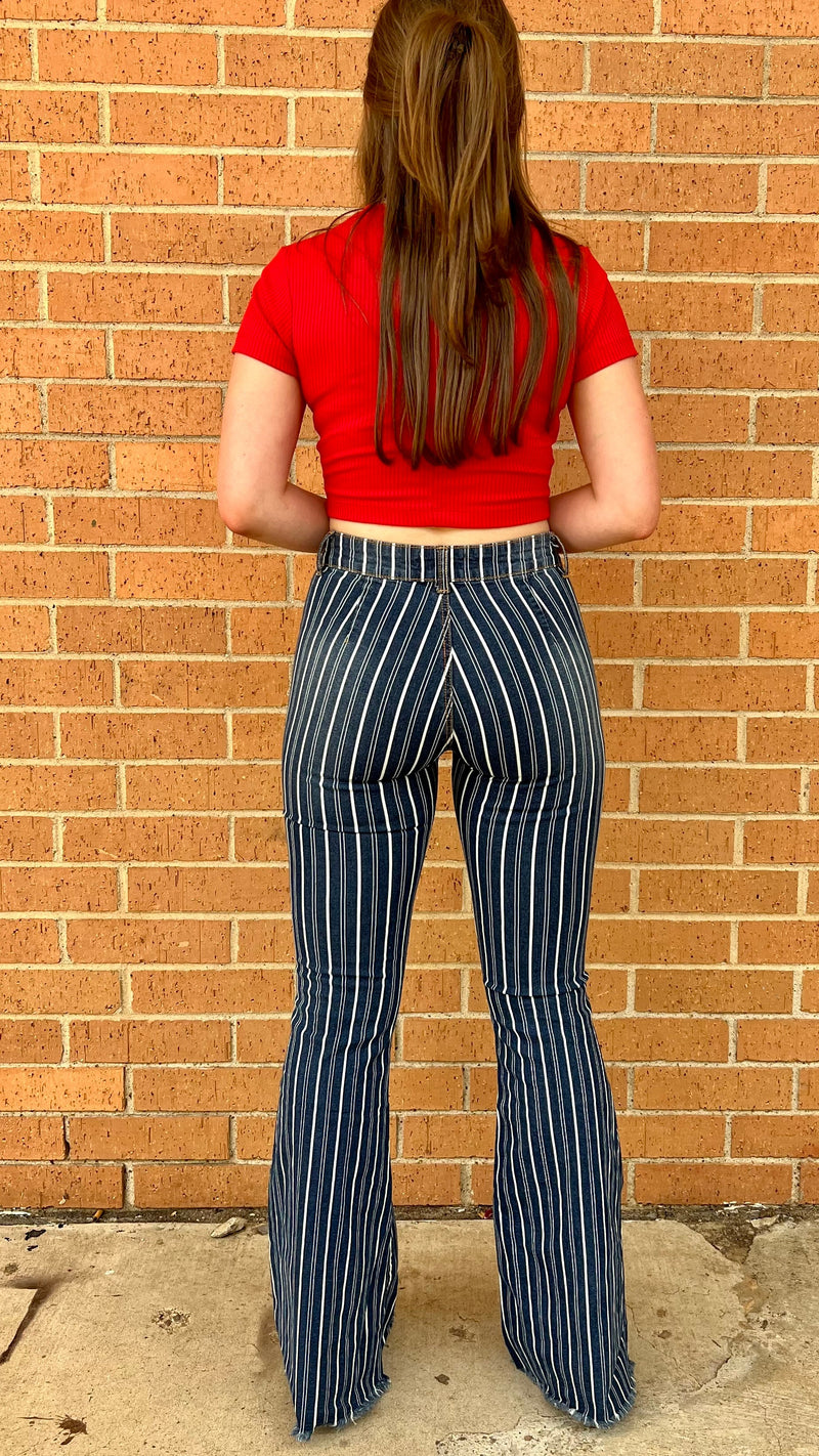 Introducing our Striped Away From It All Flares, the perfect way to stay on trend and channel your inner cowgirl! With its white stripes and mid-rise design, these denim flares will take any rodeo outfit to the next level! Yee-haw in style!  98% Cotton 2% Spandex