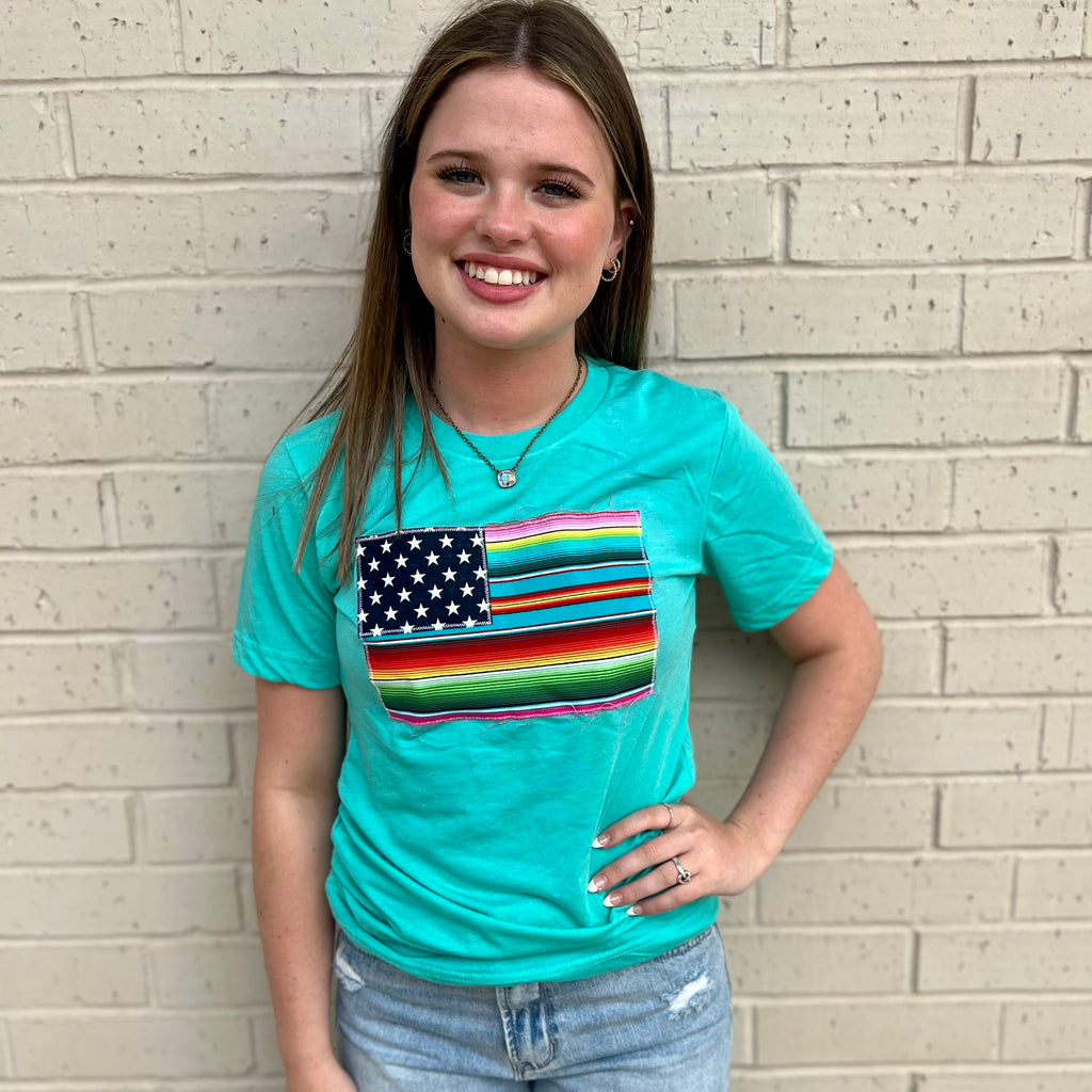 This PLUS Bright Stripes Turquoise Tee is perfect for a casual day out. It features a stylish turquoise Bella Canvas crew neck and short sleeves. Crafted with 50% Polyester, 25% Cotton, and 25% Rayon, this tee is designed with a bright colored serape flag design for a chic look.