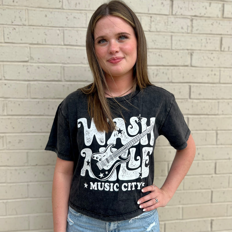 This Concert Crop Top is a perfect summer classic. Made of 100% cotton and featuring a mineral washed black fabric with white lettering, this crop top is perfect for your next music festival. The vintage graphic t-shirt look adds a bit of style to your summer wardrobe.