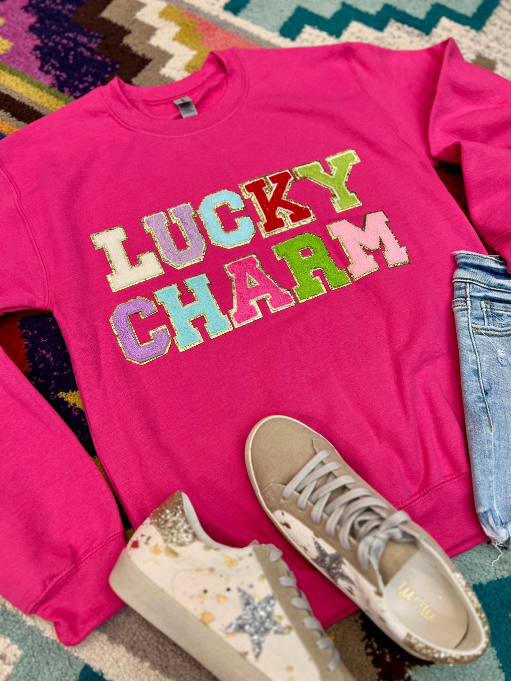 Sweatshirt. Pink sweatshirt. Lucky Charm top. Chenille letters. St. Patrick's Day Sweater. Women's sweatshirt. Women's holiday top. Cute sweatshirt. Trendy tops. Trending style. Outfits. Women's clothing. Women's boutique. Fashion trends. Easy outfits. Comfortable style. Small business. Woman owned business.