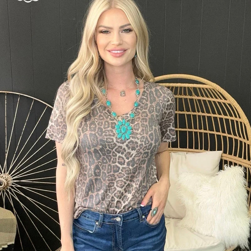  Make sure you're cheetah-level cute in this Sweet Caroline Top! This faded v-neck style makes a statement, but is still subtle enough for everyday wear. Go wild for this high-quality style!  94% modal, 6% spandex