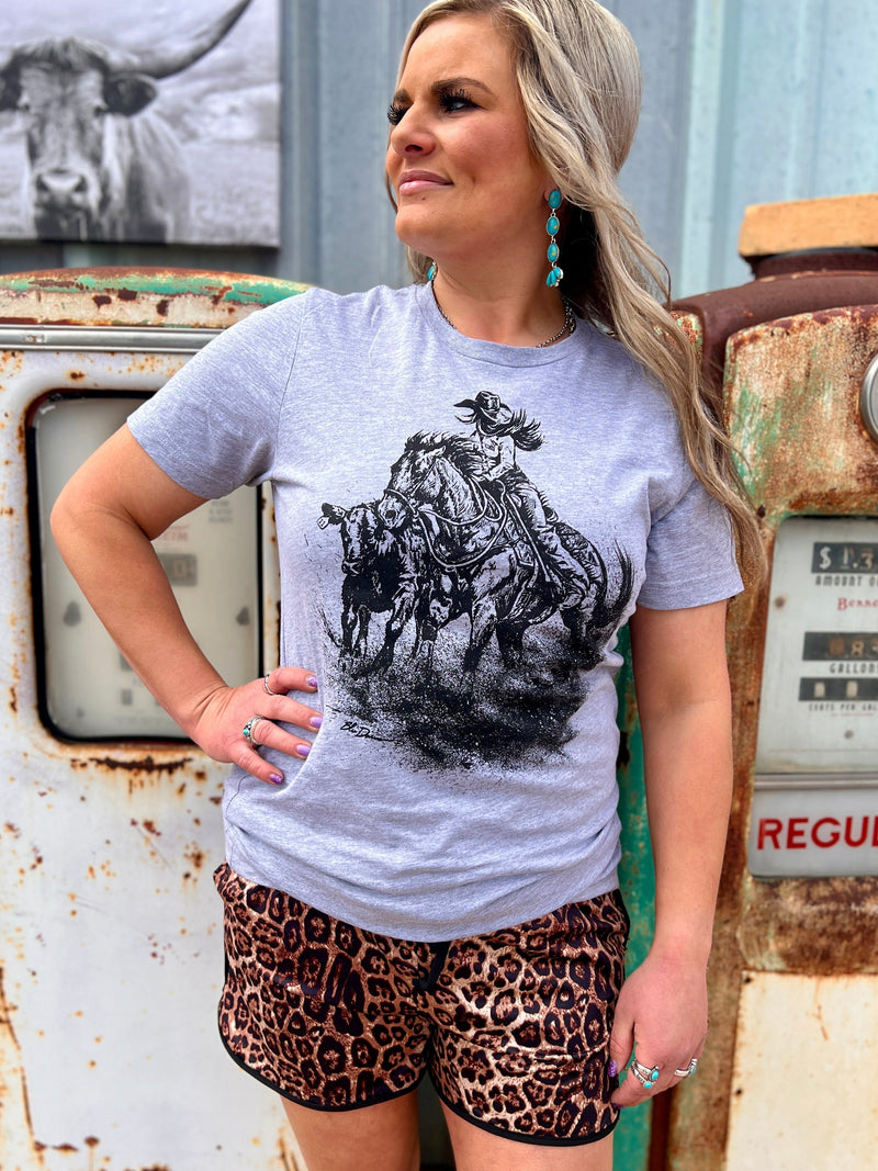 Sterling Kreek graphic tee. Women's graphic tees. Western style graphic tees. Cowgirl style graphic tee. Short sleeve graphic tee. Grey graphic tee. Rodeo T-shirt. Western boutique. Women's western boutique. tan, graphic tee, short sleeve, steer, sunset. Get Gussied Up. Small Business. Fast shipping from Texas.