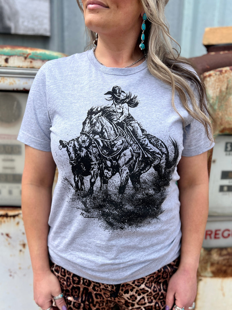 Sterling Kreek graphic tee. Women's graphic tees. Western style graphic tees. Cowgirl style graphic tee. Short sleeve graphic tee. Grey graphic tee. Rodeo T-shirt. Western boutique. Women's western boutique. tan, graphic tee, short sleeve, steer, sunset. Get Gussied Up. Small Business. Fast shipping from Texas.