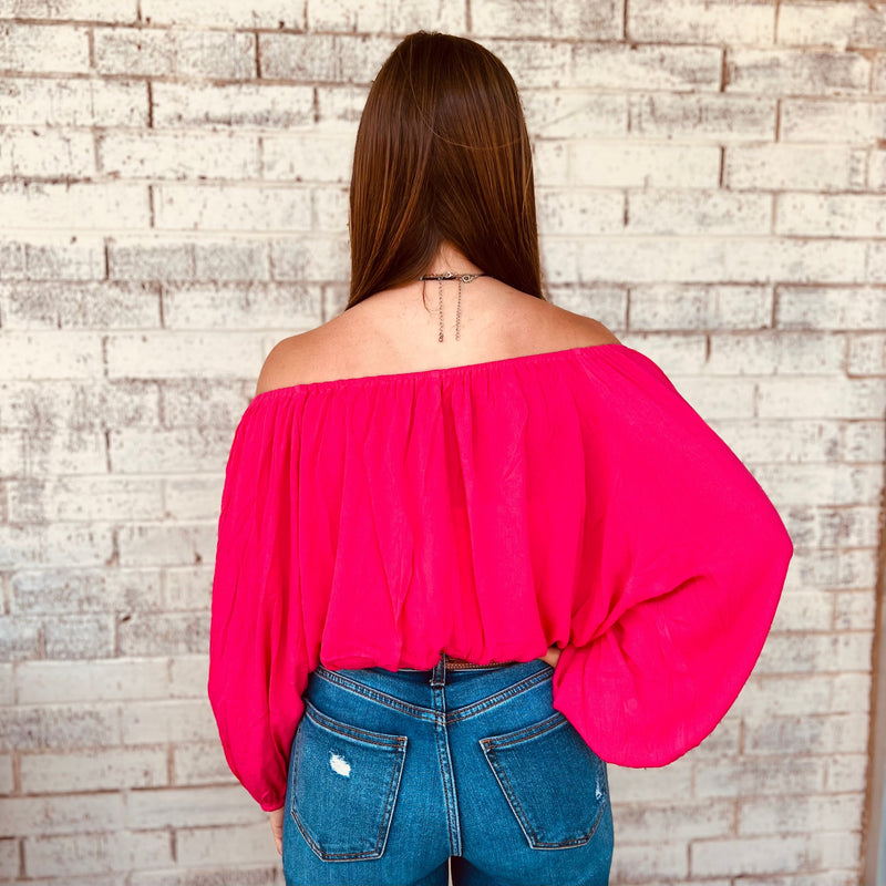 The Jenna In The Wind Top is the perfect wardrobe staple for effortless summer style. Crafted from lightweight and flowy fabric, this elegant off-shoulder top is finished with balloon sleeves and elastic bands at the wrist and waist for a flattering and comfortable fit. Its sophisticated design is ideal for dressing up with ease.  100% Rayon 