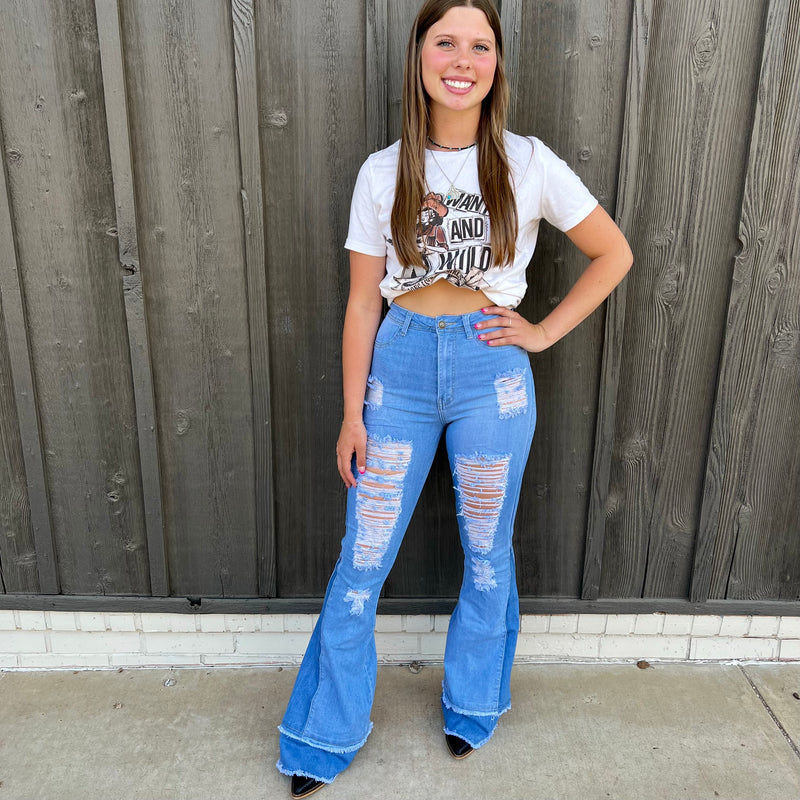 Experience denim revival in Retro Girl Light Wash Flares. Crafted with high-waisted stretch denim, these distressed flares provide a formed fit while being flattering to the figure. With a thick hem and a 70s-inspired style, these trousers offer classic charm with a modern edge.
