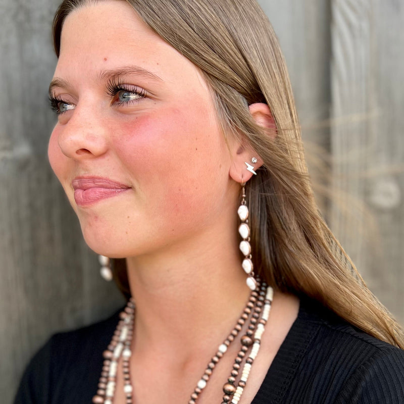 Our Linked To Copper Earrings are the perfect mix of opulence and elegance. Crafted from copper and featuring an ivory stone dangle, these earrings are the luxurious statement piece you've been searching for. At 3.5" in length, make your outfit pop with a timeless style that will endure.