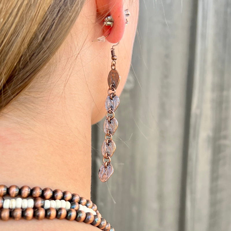 Our Linked To Copper Earrings are the perfect mix of opulence and elegance. Crafted from copper and featuring an ivory stone dangle, these earrings are the luxurious statement piece you've been searching for. At 3.5" in length, make your outfit pop with a timeless style that will endure.