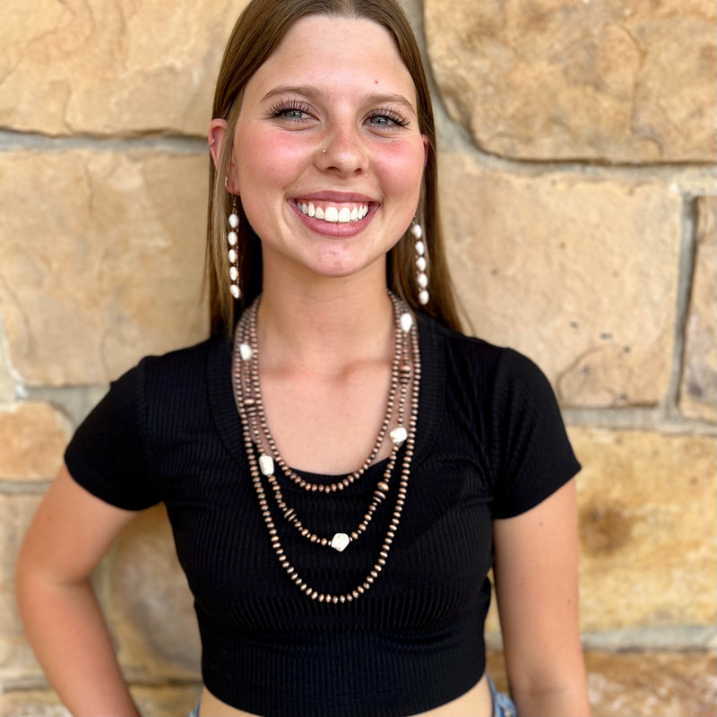 This elegant and timeless Classic Stone Necklace is perfect for those who value classic sophistication and style. Its triple-layered copper beaded design with ivory stone accents is sure to add a luxurious touch to your look. With a length of 24" it is perfect for any special occasion.