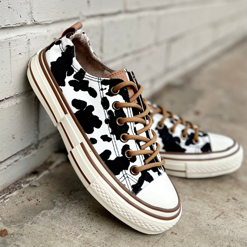These sneakers are not only cute and stylish, but the comfy as all get out! The super cushioned foot bed offers optimal comfort. Ideal for everyday wear. The rubber sole ensures stability with every step. The upper shoe is an udderly adorable black and white cow print and is a canvas like material.   True to size 