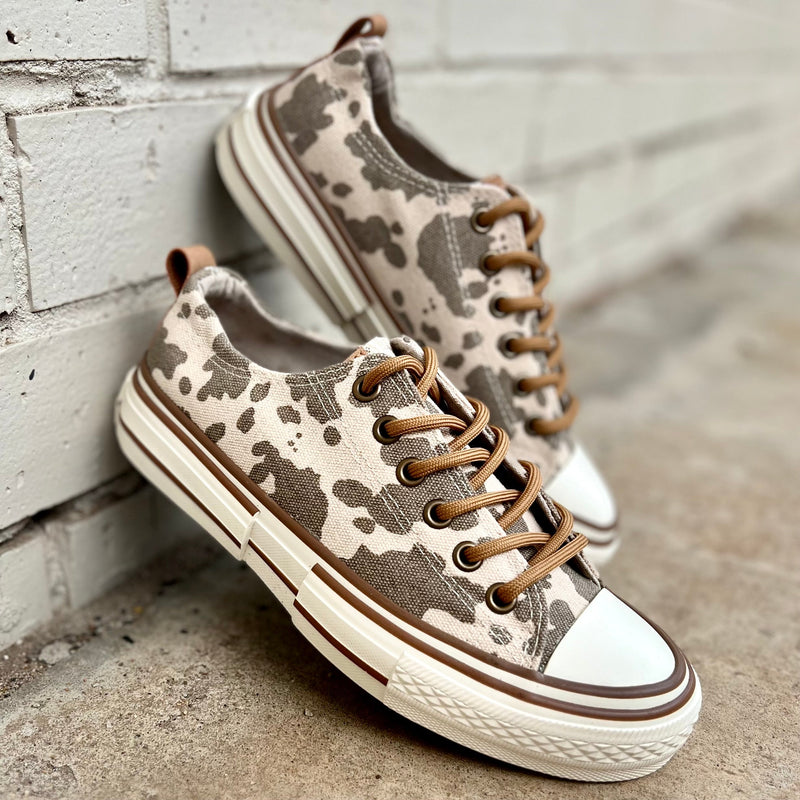 These sneakers are not only cute and stylish, but the comfy as all get out! The super cushioned foot bed offers optimal comfort. Ideal for everyday wear. The rubber sole ensures stability with every step. The upper shoe is an udderly adorable brown and cream cow print and is a canvas like material.   True to size 