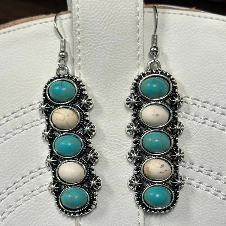 Let the Cinco Mix Dangle Earrings add some vibrant color and class to your look! These ear-pleasers have white and turquoise stones artfully arranged in a delightful dangle style. Truly the perfect accessory for any fashion fan!  length: 1.25"