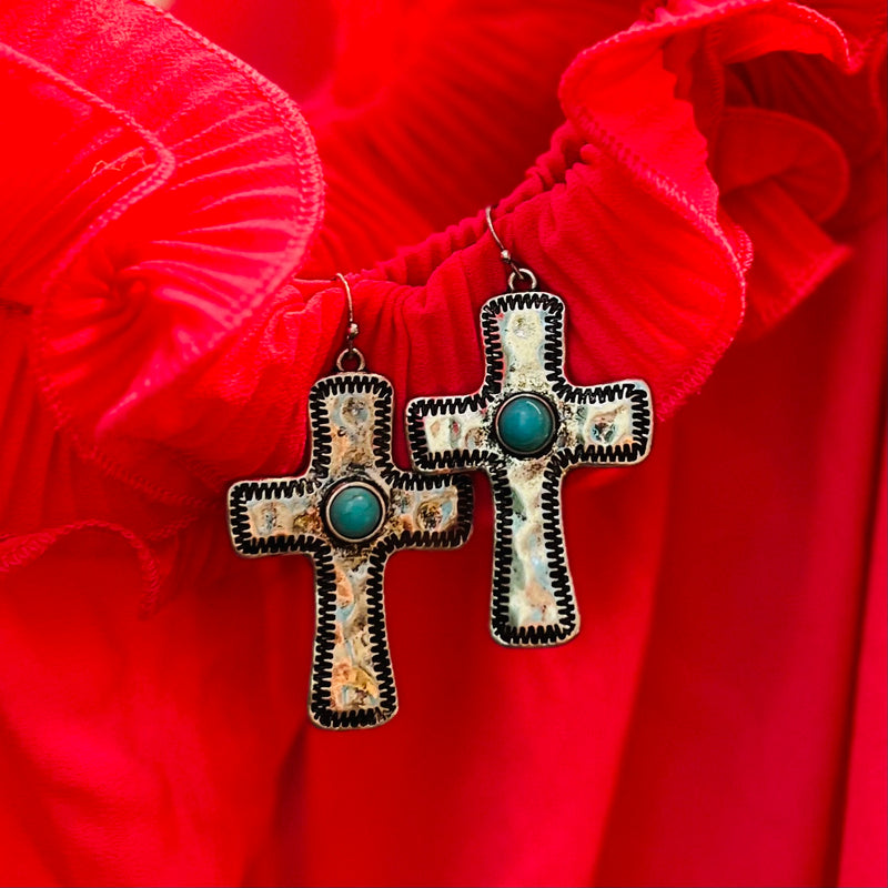 These exclusive Stitched in Him Earrings are the perfect way to showcase a luxurious sense of style. Crafted from luxuriously polished silver, each earring features a dangle fish hook and a 2" cross with a turquoise stone at its center, all stamped in exquisite detail. Add a touch of elegance to any outfit with these sumptuous earrings.