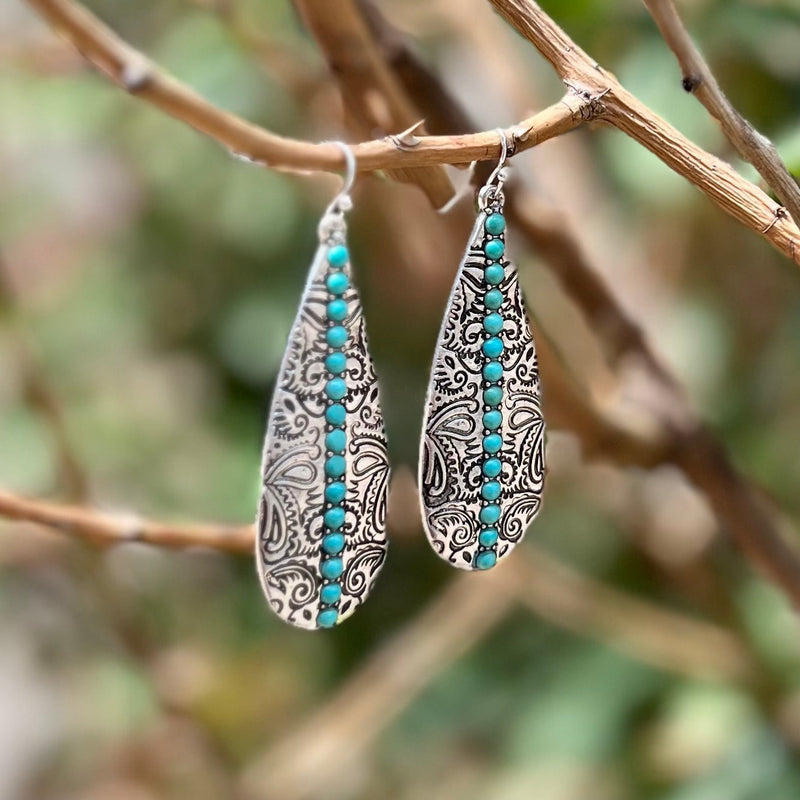 Beautifully crafted for a timeless look, the Give It To Me Straight Earrings are the perfect pick for a night out. Available in two color choices - silver and turquoise or copper and ivory - these earrings feature elegant paisley stamping and gently dangle 2.5" for a sophisticated, refined statement.