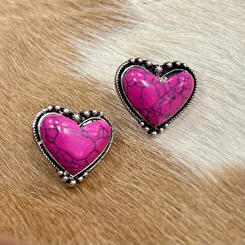 Captivate your look with our My Pink Achy Breaky Heart Stud Earrings, featuring a high polish Western concho style heart casting highlighted by a stylish pink gemstone. With a timeless vintage Western feel, the earrings make a vibrant and sophisticated statement.  1"
