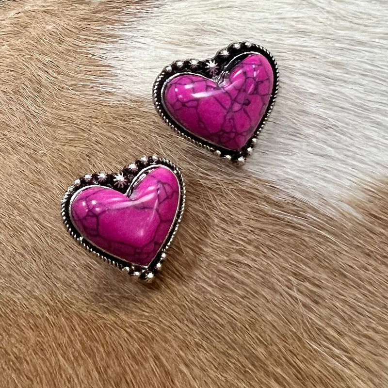 Captivate your look with our My Pink Achy Breaky Heart Stud Earrings, featuring a high polish Western concho style heart casting highlighted by a stylish pink gemstone. With a timeless vintage Western feel, the earrings make a vibrant and sophisticated statement.  1"