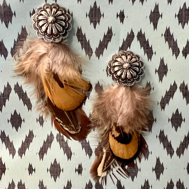 Indulge in these luxurious brown feather dangle earrings, crafted with multi shade brown feathers and finished with a high-shine silver concho stud. Perfect for lending a subtle elegance to your look, their 2-inch length adds an ideal finishing touch
