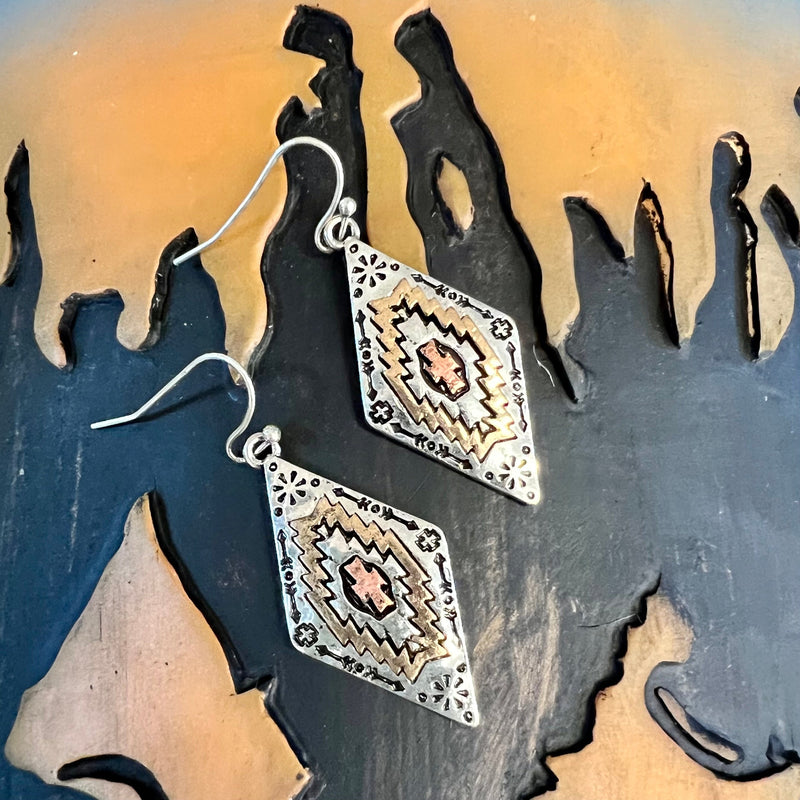 These A Little Bit of This earrings feature a unique aztec-inspired design in four striking colors: silver, gold, black, and copper. With a dangle of 2.5" and a fish hook back, they offer an exquisite combination of fashion and sophistication. Make a subtle yet powerful statement with these exquisite earrings.