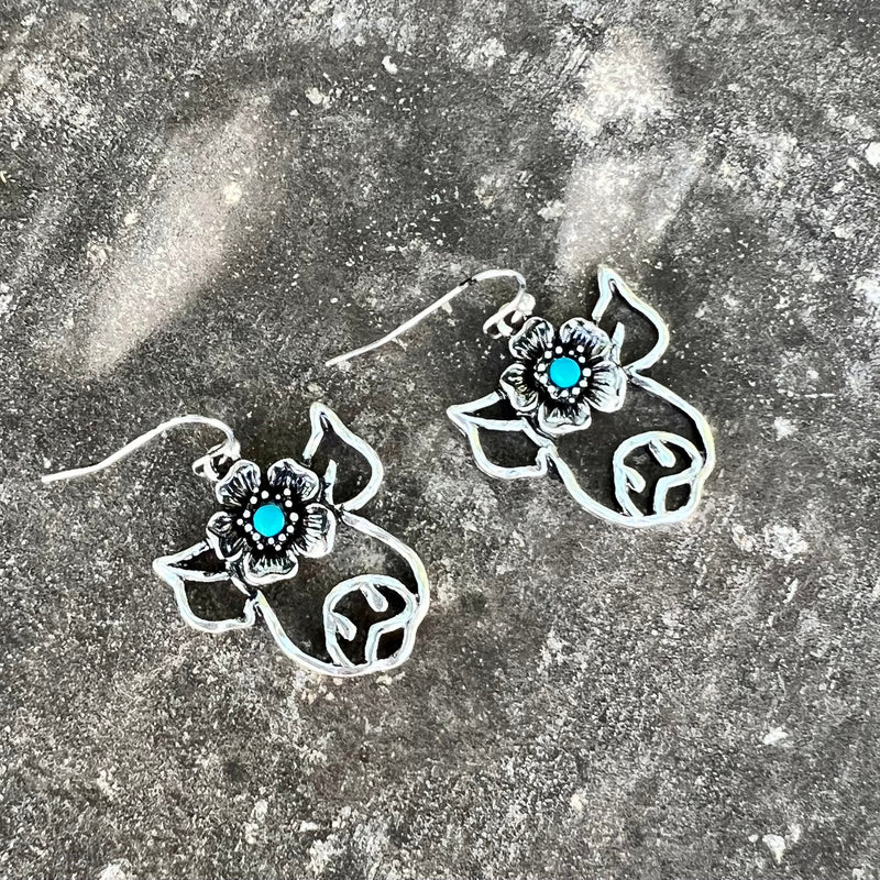 These exquisite Charlotte Earrings bring a classic elegance to any look. Crafted in sterling silver with a pig, flower and delicate turquoise stone hanging from a classic fish hook, they are the perfect finishing touch for any wardrobe. Showcase your impeccable style with the Charlotte Earrings and make a statement that won't soon be forgotten.
