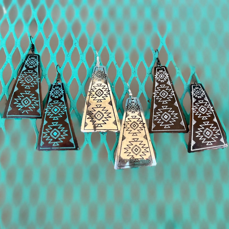 These My Temple Earrings add a sophisticated flair to any outfit. Made from premium metals with an aztec-stamped design, each earring is available in three unique colors - silver, copper/turquoise, and copper/ivory - and each dangles 3" in length. They showcase the perfect balance between elegance and subtlety, making them the perfect choice for any classic wardrobe.