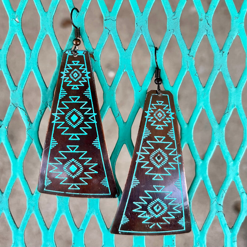 These My Temple Earrings add a sophisticated flair to any outfit. Made from premium metals with an aztec-stamped design, each earring is available in three unique colors - silver, copper/turquoise, and copper/ivory - and each dangles 3" in length. They showcase the perfect balance between elegance and subtlety, making them the perfect choice for any classic wardrobe.