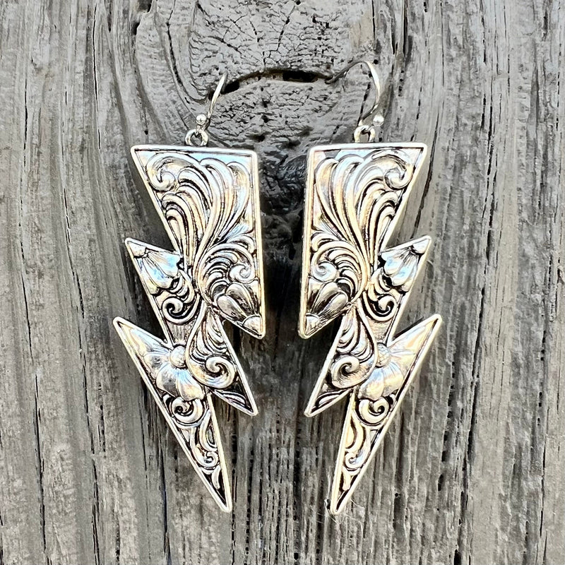 Add a luxurious touch to your look with our Paisley Bolt Earrings. Handcrafted with a delicate silver paisley scroll design, these earrings feature a classic lightning bolt design and dangle from a beautiful fish hook. With a length of 2", these bolts make the perfect statement piece.